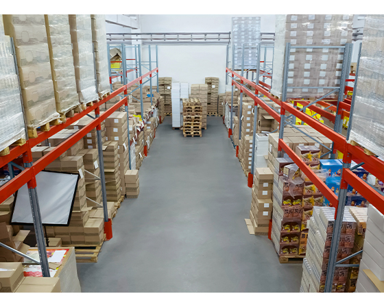 Organized warehouse aisles with shelves of boxed inventory.