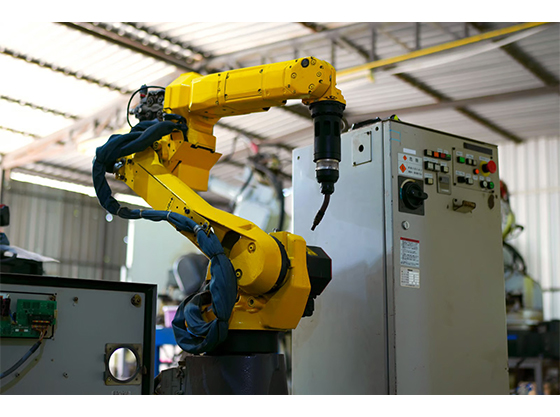 Industrial robot controller system connected to a robotic arm in a manufacturing facility.